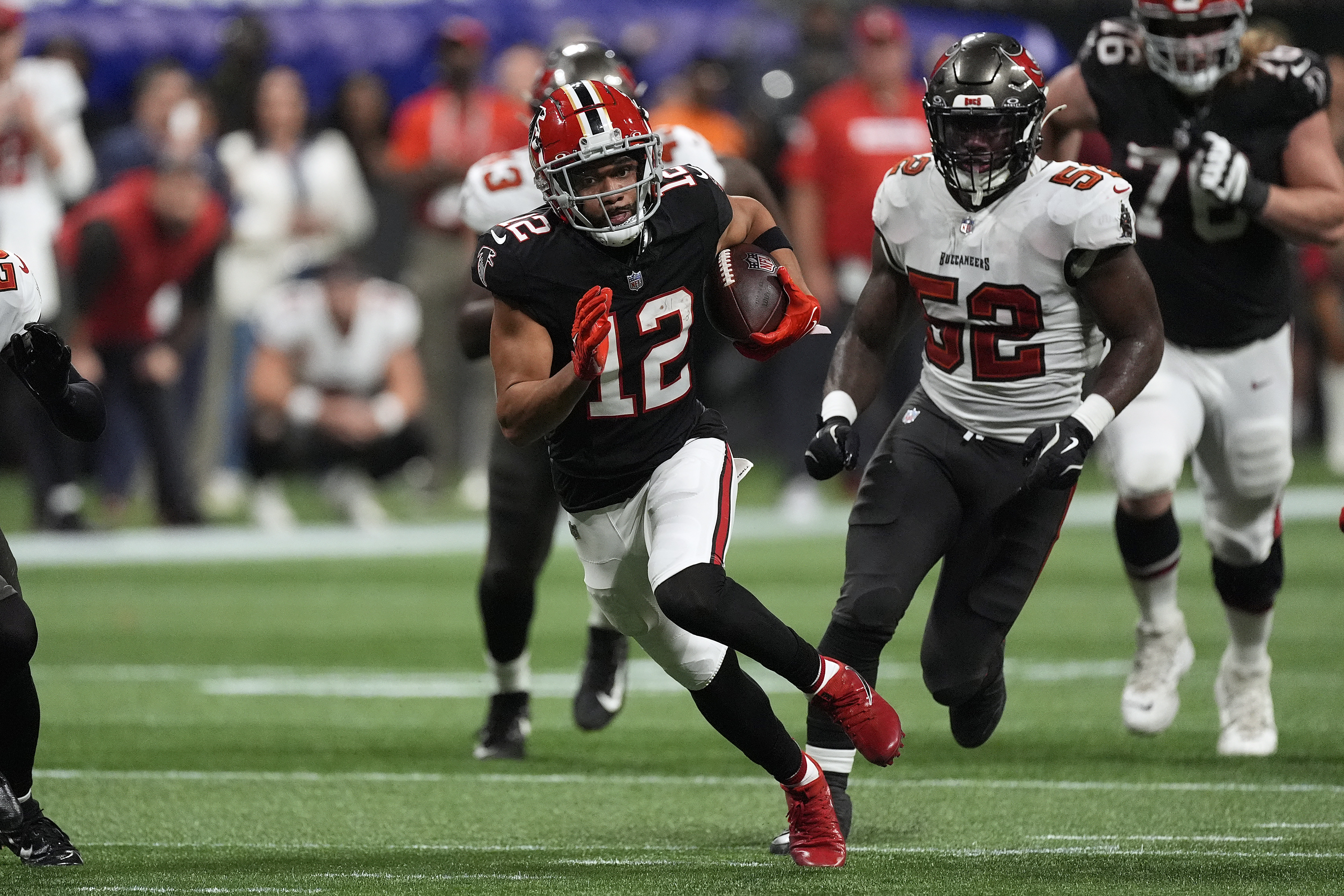 Atlanta Falcons wide receiver KhaDarel Hodge (12) outrusn Tampa Bay Buccaneers linebacker K.J. Britt (52) to the endzone to score the game-winning touchdown against the Tampa Bay Buccaneers during overtime in an NFL football game Friday, Oct. 4, 2024, in Atlanta.