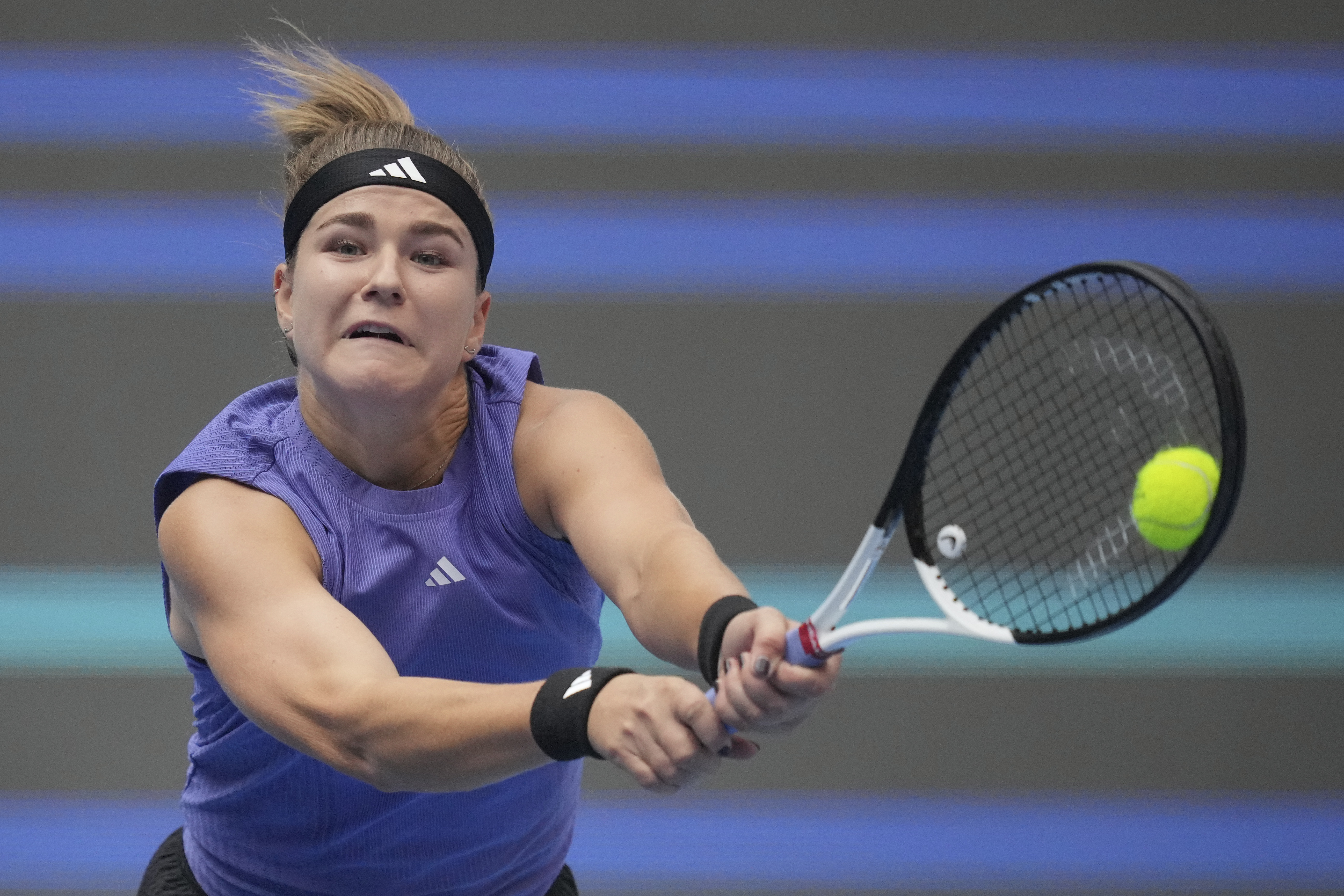 Karolina Muchova of the Czech Republic returns a shot to Aryna Sabalenka of Belarus during the women's singles quarterfinals match of the China Open tennis tournament, at the National Tennis Center in Beijing, Friday, Oct. 4, 2024.
