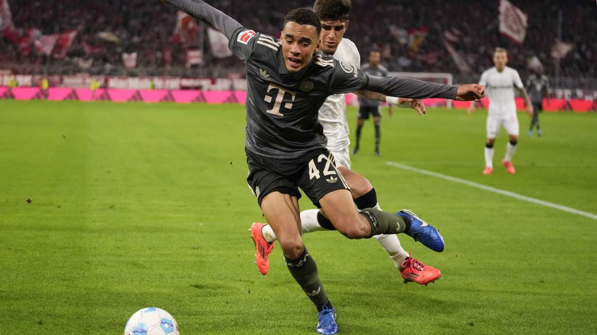 Bayern's Jamal Musiala, left, and Leverkusen's Piero Hincapie vie for the ball during the Bundesliga soccer match between Bayern Munich and Leverkusen at the Allianz Arena in Munich, Germany, Saturday, Sept. 28, 2024.