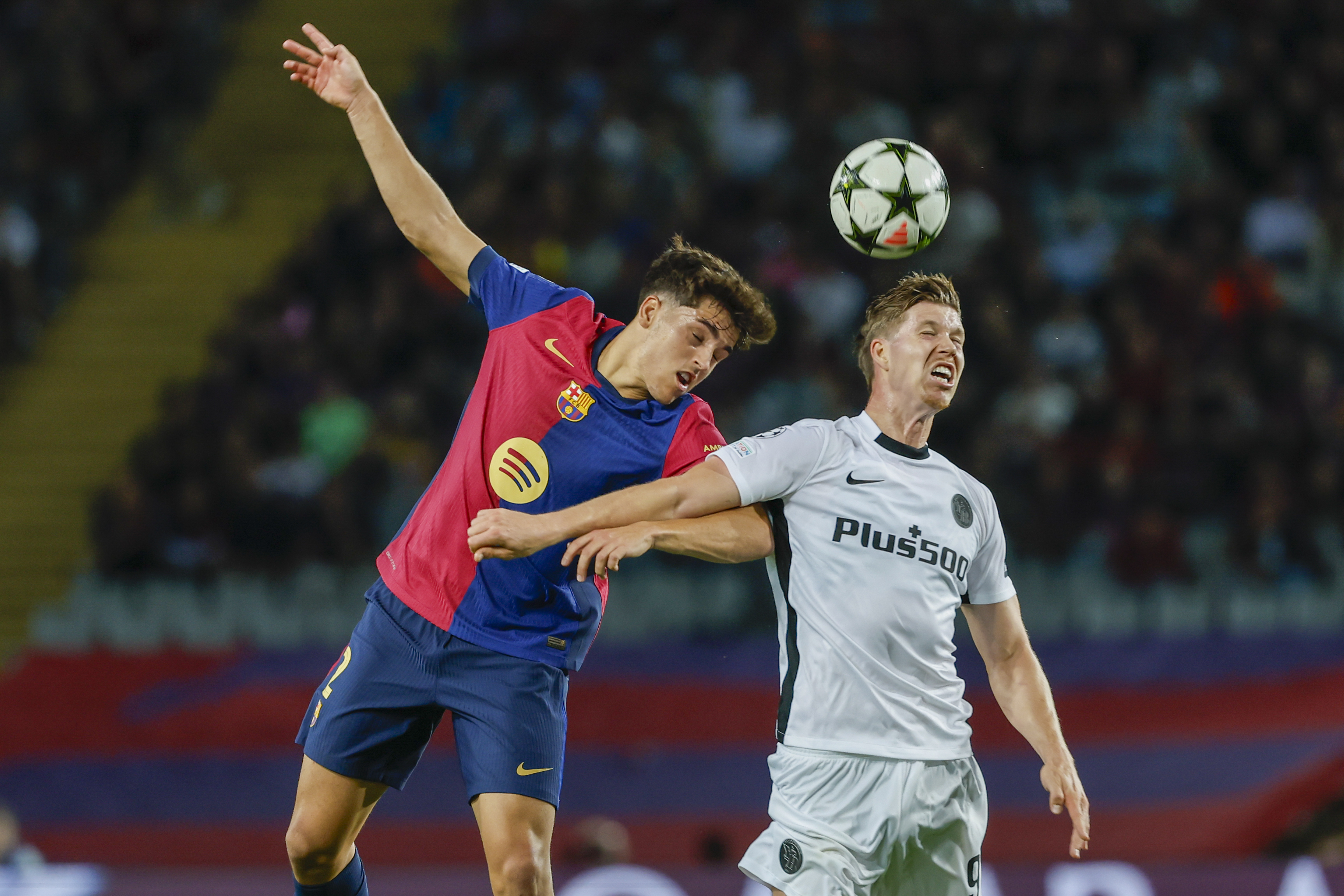 Young Boys' Cedric Itten, right, jumps for a header with Barcelona's Pau Cubarsi during the Champions League soccer match between Barcelona and Young Boys at the Lluis Companys Olympic Stadium in Barcelona, Spain, Tuesday, Oct. 1, 2024.