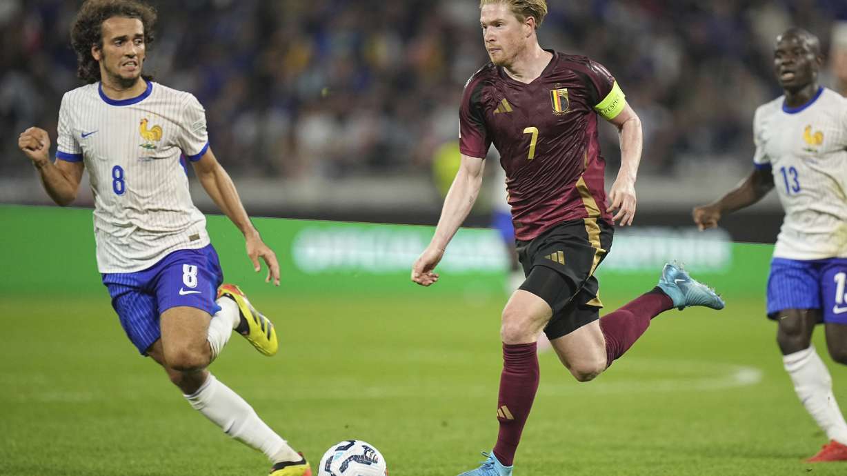 France's Matteo Guendouzi, left, runs to stop Belgium's Kevin De Bruyne during the UEFA Nations League soccer match between France and Belgium at the Groupama stadium in Decines, outside Lyon, France, Monday, Sept. 9, 2024.