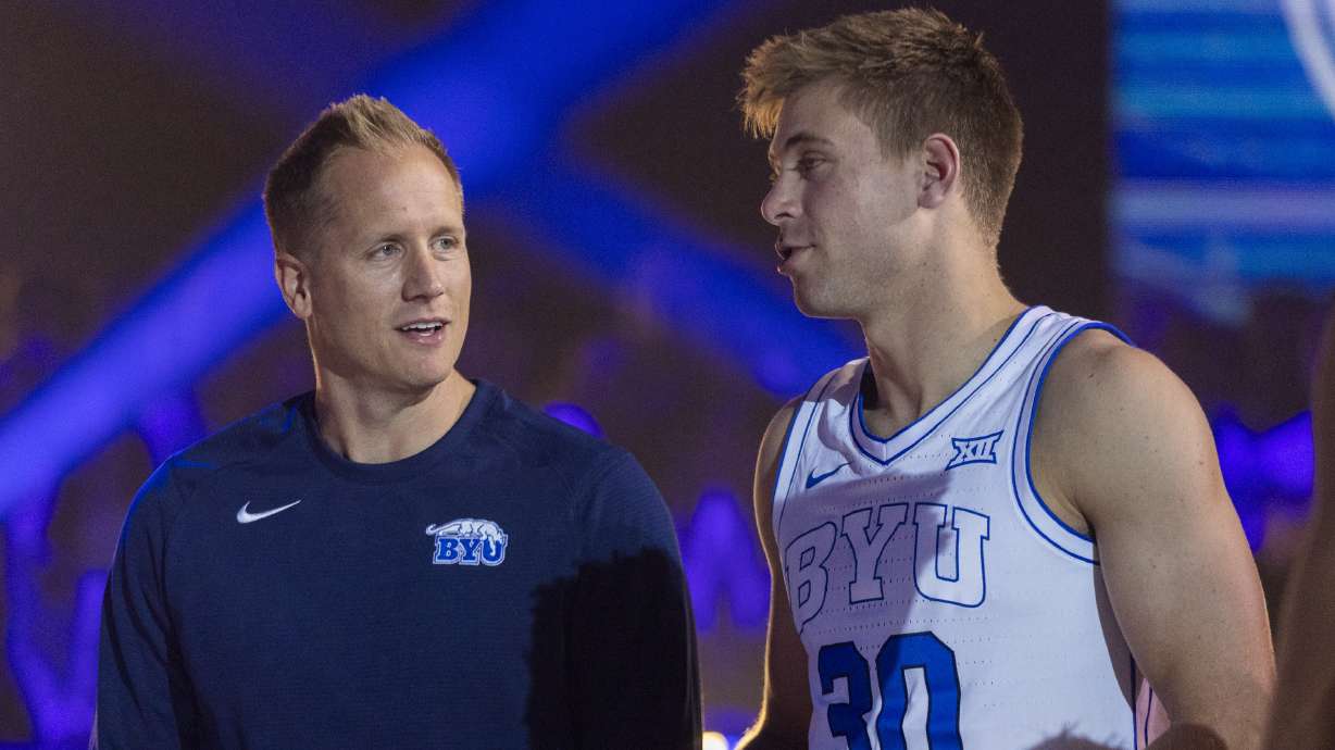 Brigham Young Cougars head coach Kevin Young talks with Dallin Hall (30) during Marriott Madness at the Marriott Center on the campus of Brigham Young University in Provo on Thursday, Oct. 3, 2024.