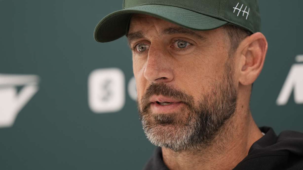 New York Jets quarterback Aaron Rodgers (8) speaks during a press conference in Ware, England, Friday, Oct. 4, 2024, ahead of the game between New York Jets and Minnesota Vikings at the Tottenham Hotspur stadium on Sunday.