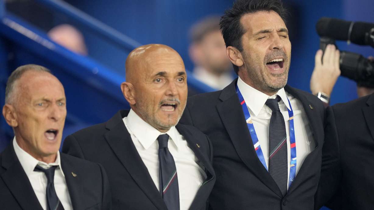 Former Italian goalkeeper Gianluigi Buffon, right, sings the national anthem wit Italy head coach Luciano Spalletti, center, before the UEFA Nations League soccer match between France and Italy at the Parc des Princes in Paris, Friday, Sept. 6, 2024.