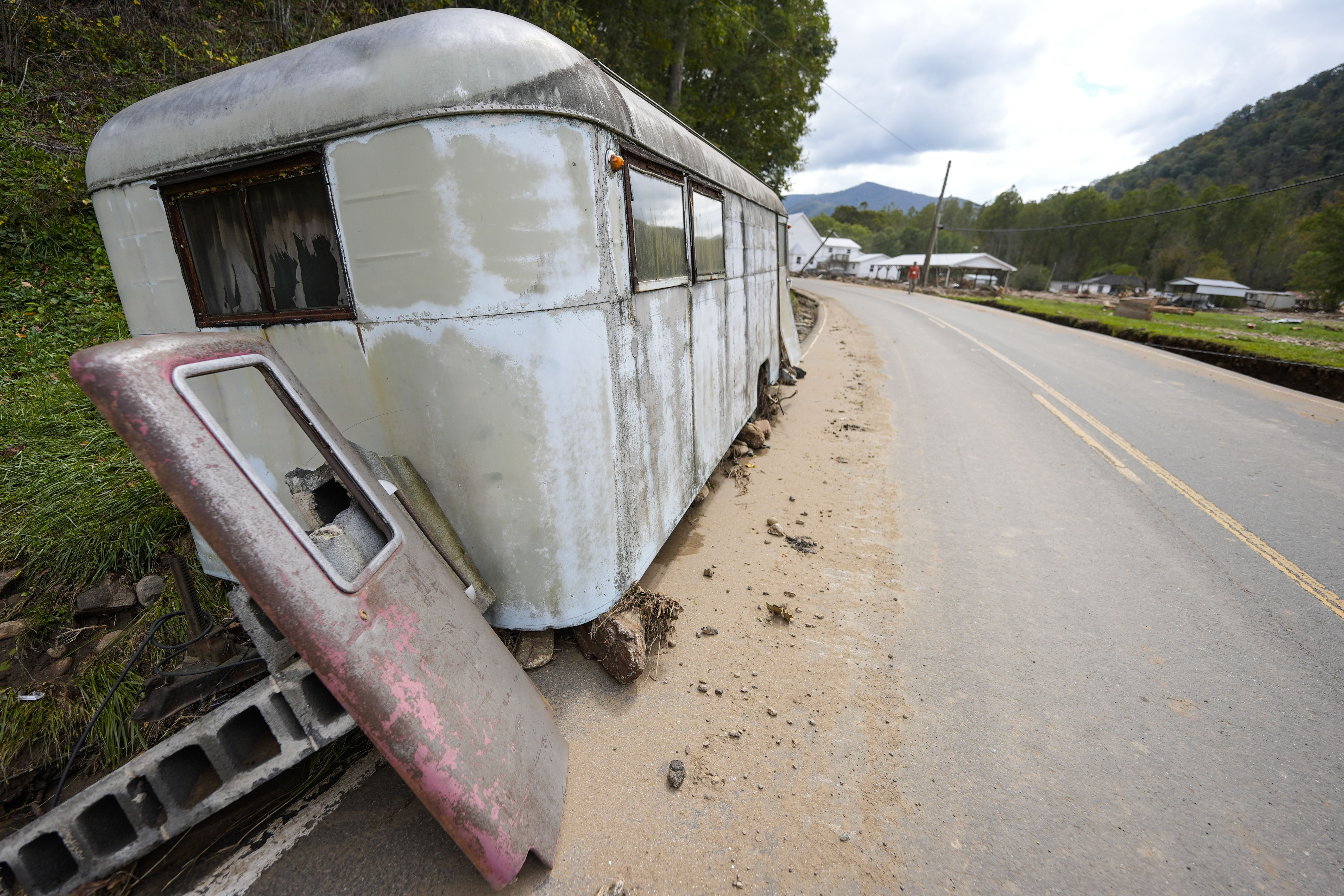 A trailer moved by floodwater sits on the side of a road in the aftermath of Hurricane Helene, Thursday in Pensacola, N.C. Health workers are distributing Benadryl and epinephrine injections to communities after flooding has caused bees and yellow jackets to swarm from underground nests. 