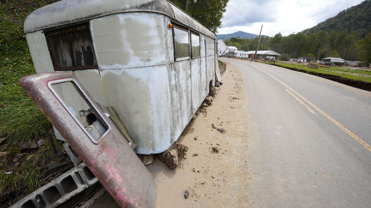 A trailer moved by floodwater sits on the side of a road in the aftermath of Hurricane Helene, Thursday in Pensacola, N.C. Health workers are distributing Benadryl and epinephrine injections to communities after flooding has caused bees and yellow jackets to swarm from underground nests.