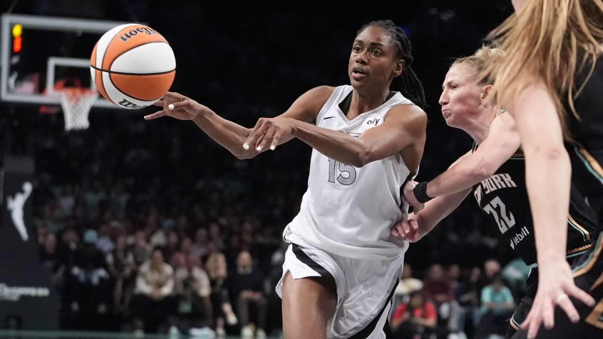Las Vegas Aces' Tiffany Hayes (15) passes away from New York Liberty's Courtney Vandersloot (22) during the second half of a WNBA basketball semifinal game, Tuesday, Oct. 1, 2024, in New York. The Liberty won 88-84.