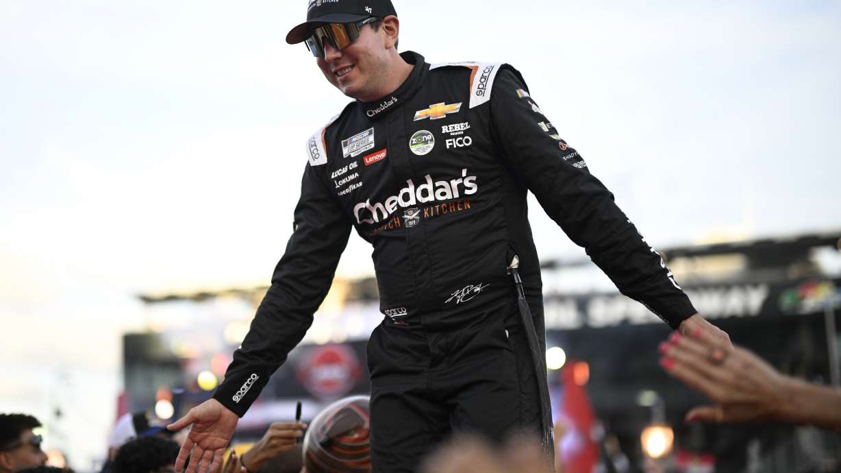 FILE - Kyle Busch interacts with spectators while walking down a runway during driver introductions before a NASCAR Cup Series auto race at Daytona International Speedway, Aug. 24, 2024, in Daytona Beach, Fla.