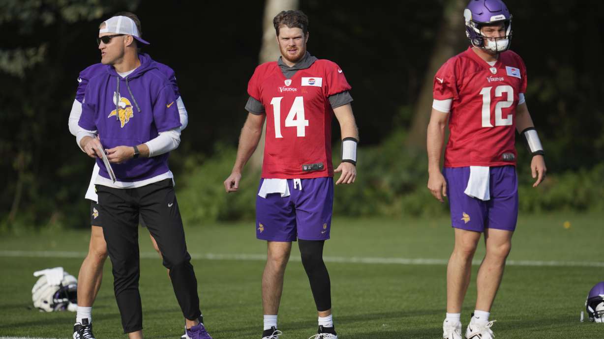 Minnesota Vikings quarterback Sam Darnold (14) and Nick Mullens (12) look on during NFL football practice at The Grove in Watford, England, Friday, Oct. 4, 2024.