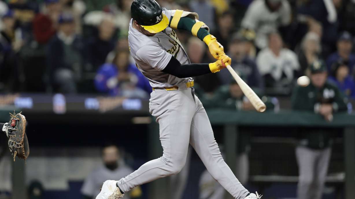 Oakland Athletics' Brent Rooker hits a two-run home run on a pitch from Seattle Mariners starting pitcher Emerson Hancock during the fifth inning in a baseball game, Saturday, Sept. 28, 2024, in Seattle.