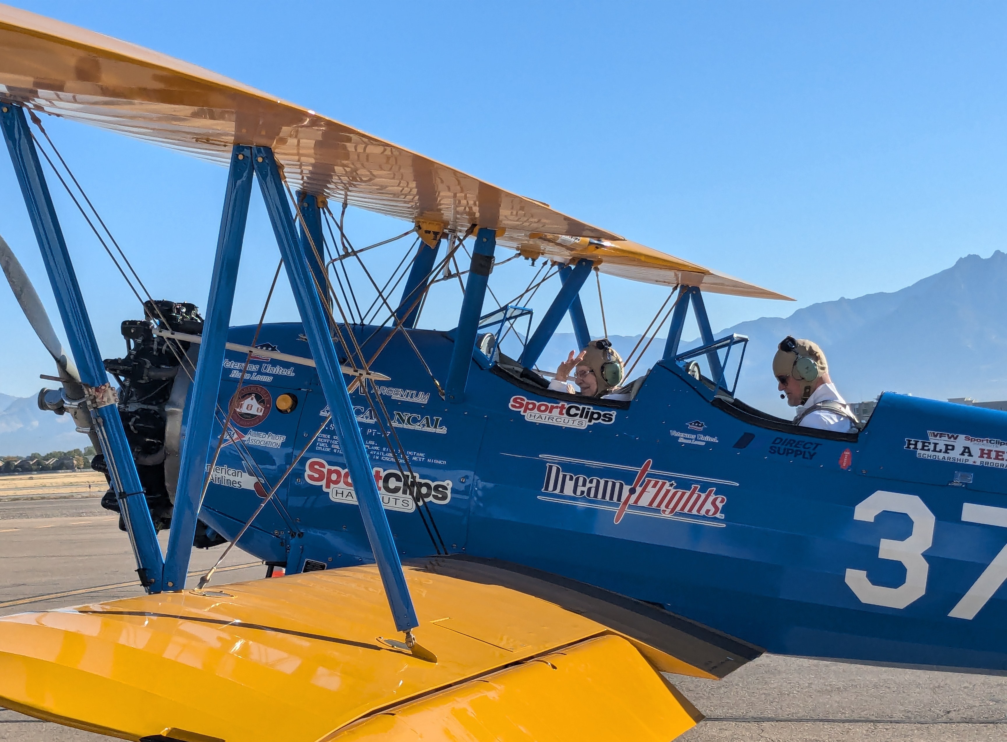 A veteran rides in a restored open-cockpit WWII-era biplane in West Jordan on Friday. The flights were made for local veterans and others from The Ridge Senior Living through Dream Flights.