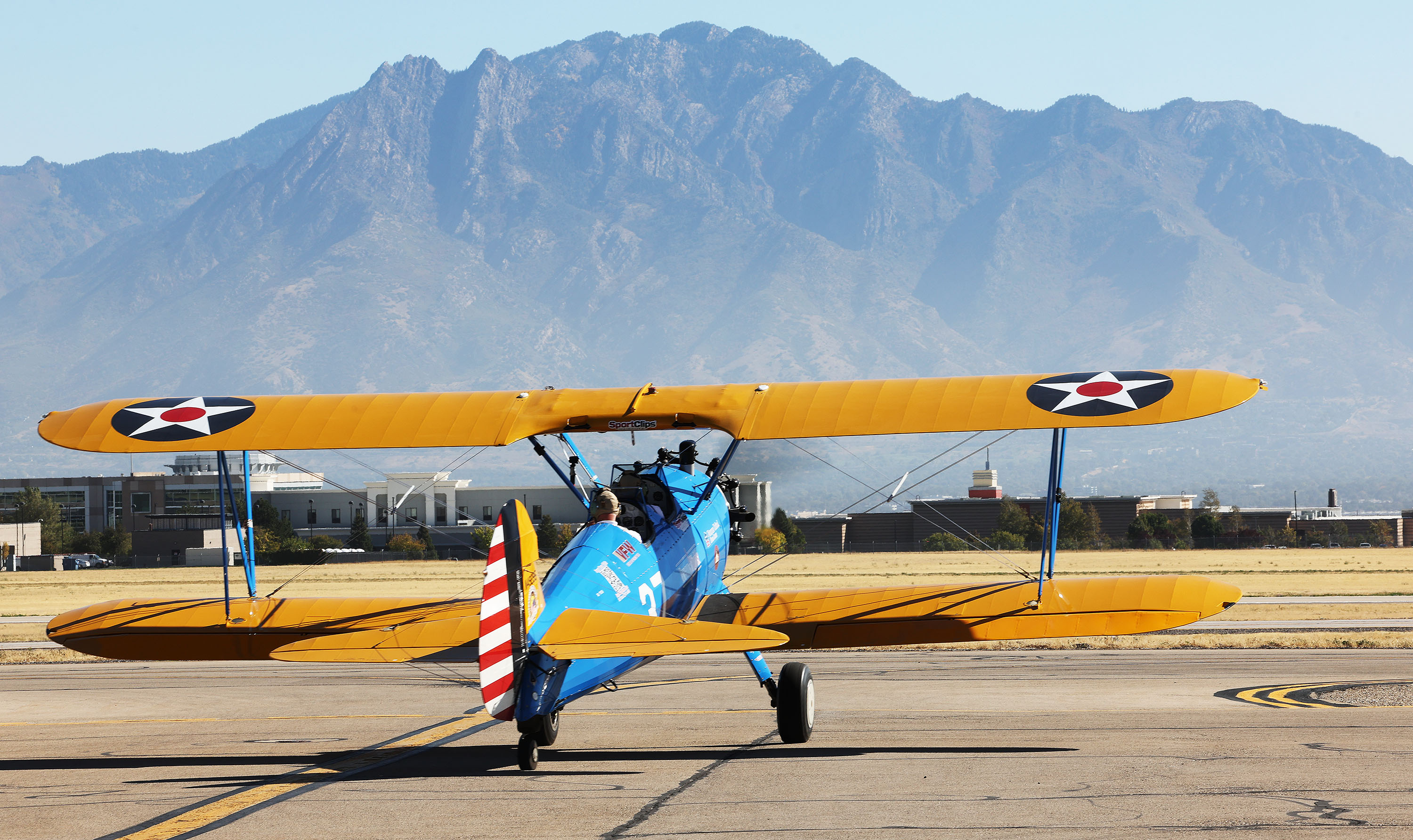 A veteran rides in a restored open-cockpit WWII-era biplane in West Jordan on Friday. The flights were made for local veterans and others from The Ridge Senior Living through Dream Flights.