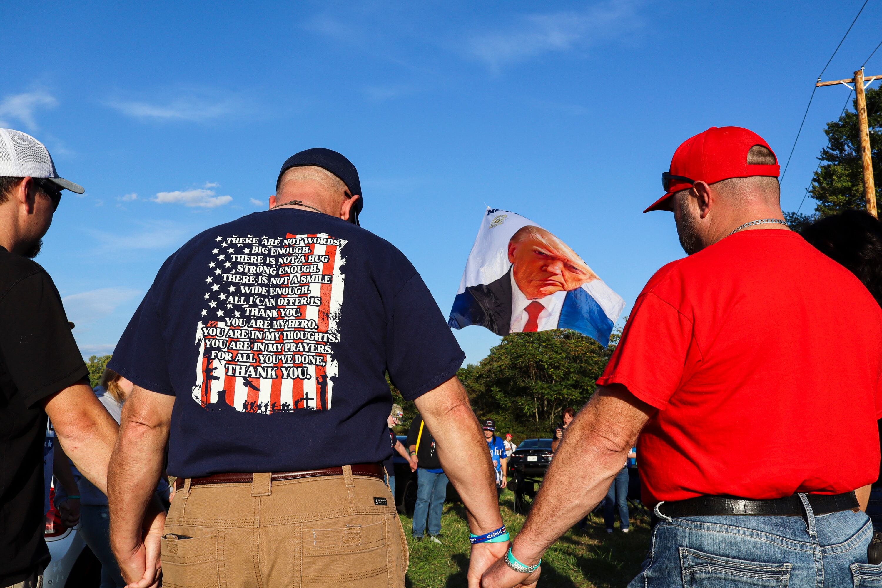 A group of former President Donald Trump's supporters join in a prayer gathering in Butler, Pa., on Friday. Trump will return to Butler on Saturday for the first time since the attempted assassination there in July.