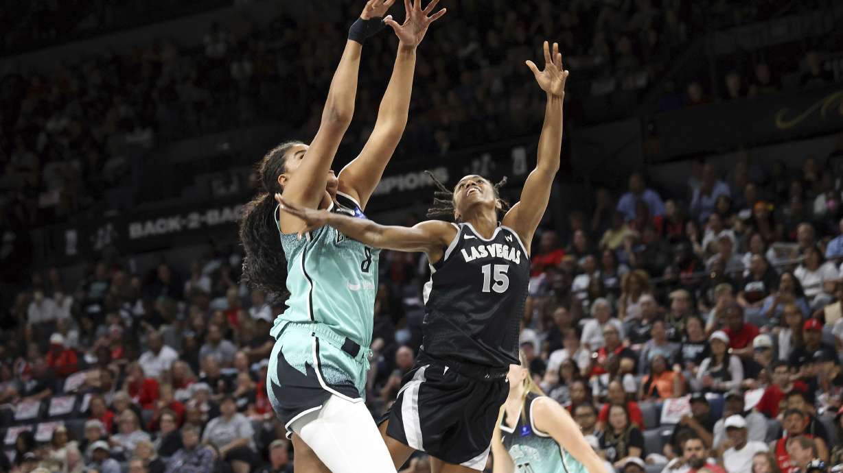 Las Vegas Aces guard Tiffany Hayes (15) is fouled by New York Liberty forward Nyara Sabally (8) during a WNBA basketball semifinal game Friday, Oct. 4, 2024, in Las Vegas.