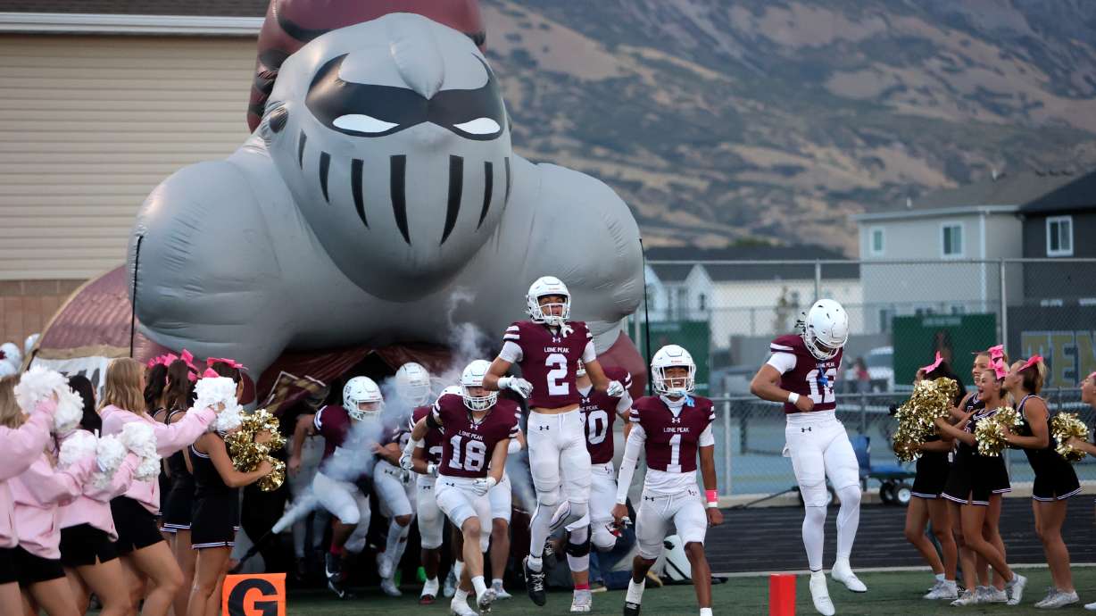 Lone Peak players enter the stadium to play Skyridge in a varsity football game at Lone Peak High School in Highland on Friday, Oct. 4, 2024. Skyridge won 21-17.
