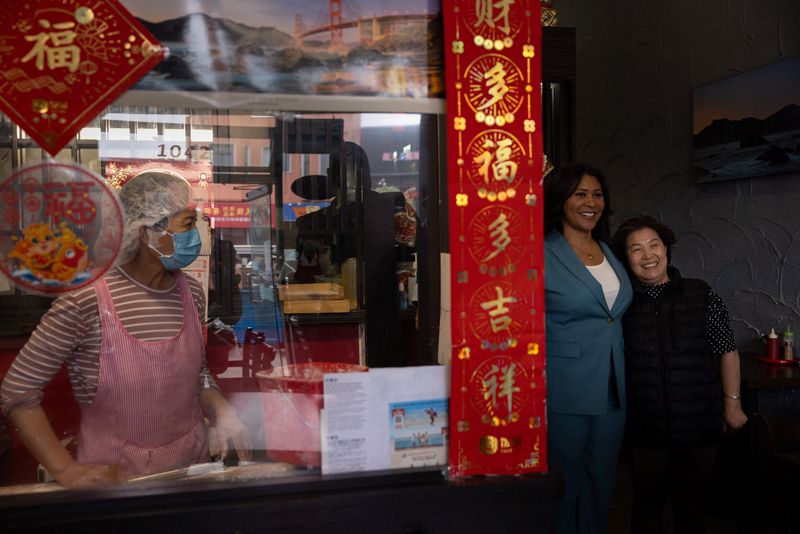 San Francisco mayor and incumbent candidate London Breed pose for a picture with a local restaurant owner during a campaign event in San Francisco, Calif., Aug. 29.