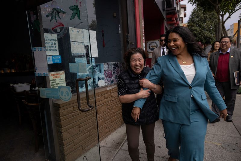 San Francisco mayor and incumbent candidate London Breed walks along with a local restaurant owner during a campaign event in San Francisco, Calif., Aug. 29.