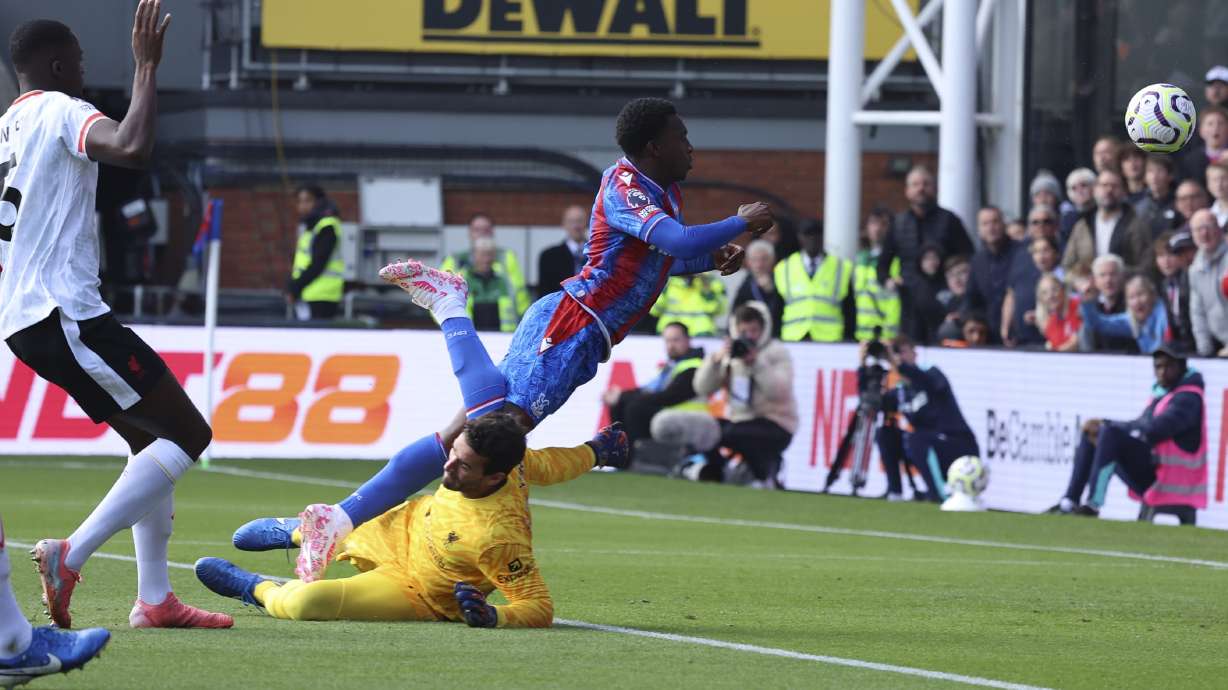 Crystal Palace's Eddie Nketiah, centre, and Liverpool's goalkeeper Alisson challenge for the ball during the English Premier League soccer match between Crystal Palace and Liverpool at Selhurst Park in London, Saturday, Oct. 5, 2024.