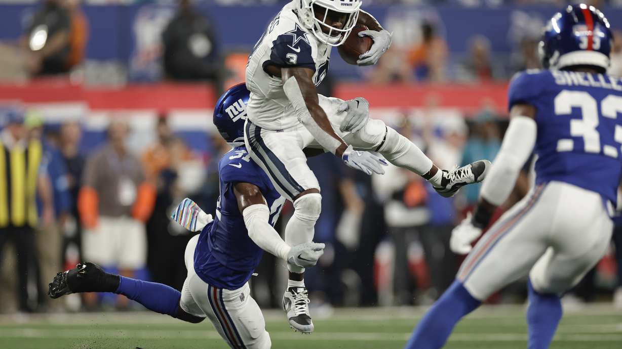 Dallas Cowboys wide receiver Brandin Cooks (3) tries to avoid a tackle from New York Giants safety Tyler Nubin (31) during the first quarter of an NFL football game, Thursday, Sept. 26, 2024, in East Rutherford, N.J.