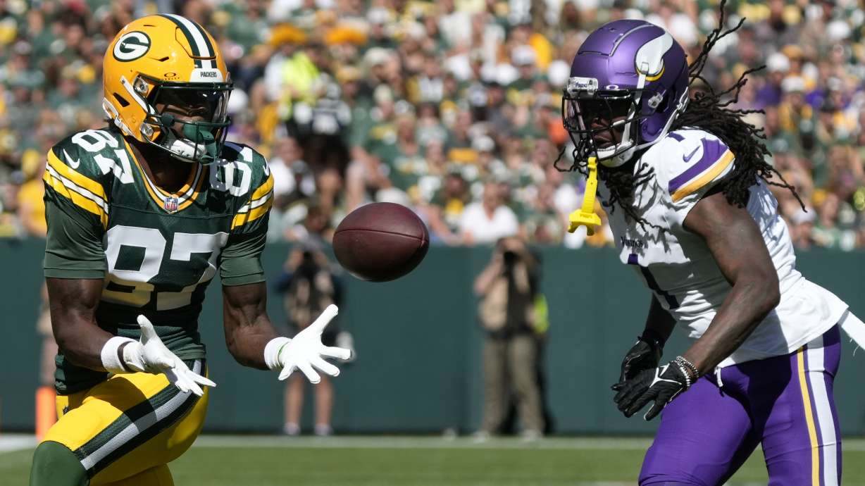 Green Bay Packers wide receiver Romeo Doubs (87) makes a catch past Minnesota Vikings cornerback Shaq Griffin, right, during the first half of an NFL football game Sunday, Sept. 29, 2024, in Green Bay, Wis.