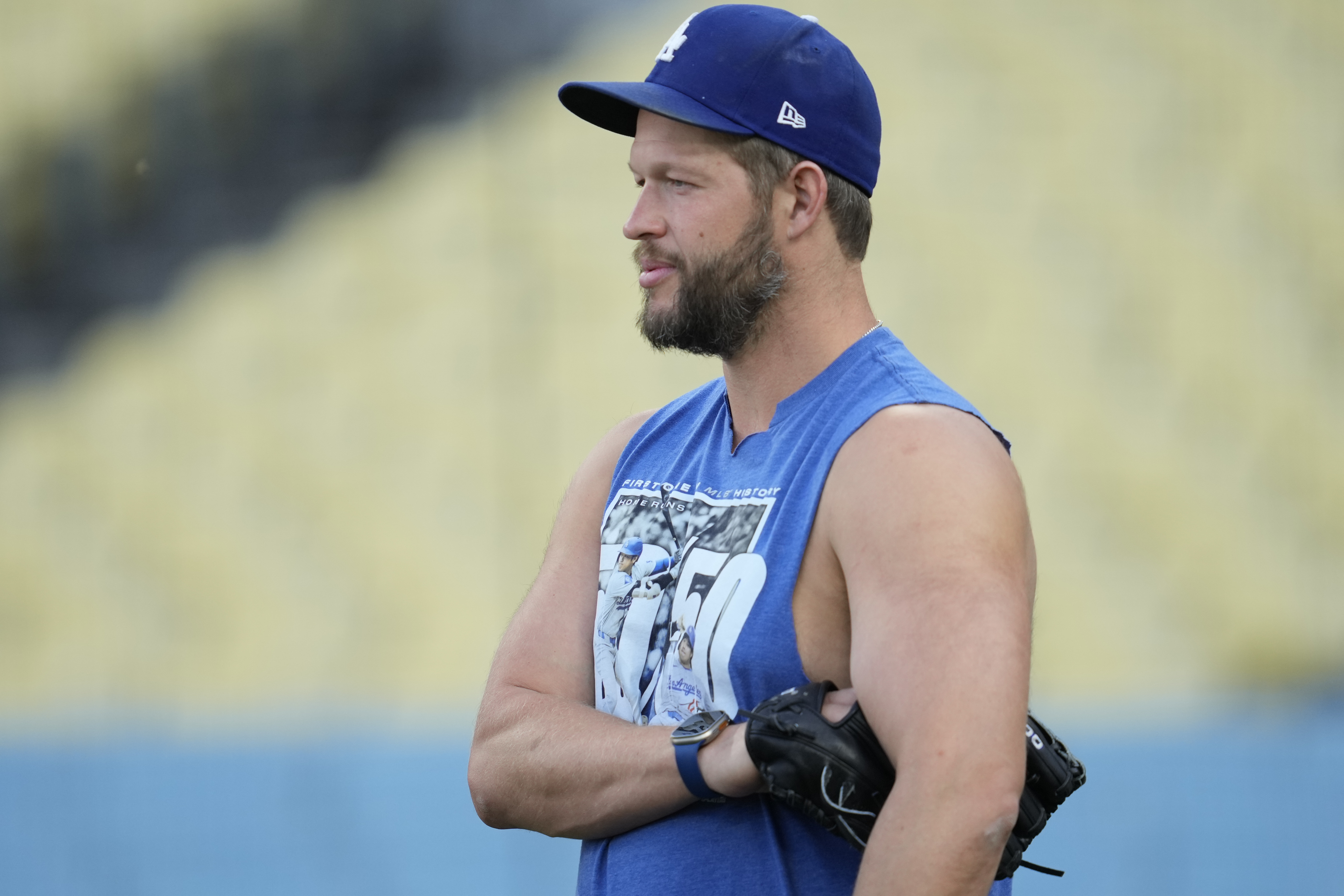 Los Angeles Dodgers pitcher Clayton Kershaw stands on the field during practice in preparation for Game 1 of a baseball NL Division Series against the San Diego Padres in Los Angeles, Friday, Oct. 4, 2024.