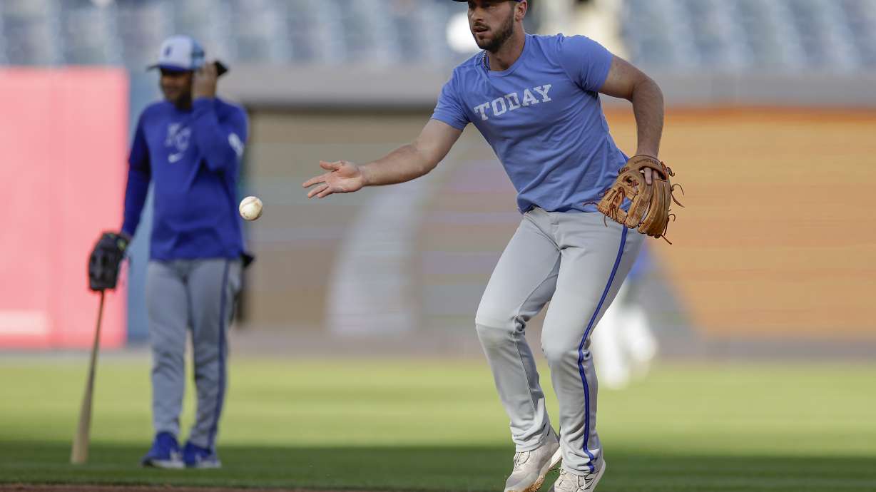 Kansas City Royals shortstop Paul DeJong (15) fields balls during batting practice before Game 1 of the Major League Baseball division series against the New York Yankees, Saturday, Oct. 5, 2024, in New York.