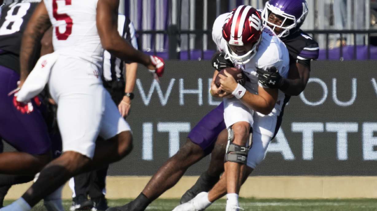 Indiana quarterback Kurtis Rourke is sacked by Northwestern defensive lineman Anto Saka, right, during the first half of an NCAA college football game in Evanston, Ill., Saturday, Oct. 5, 2024.