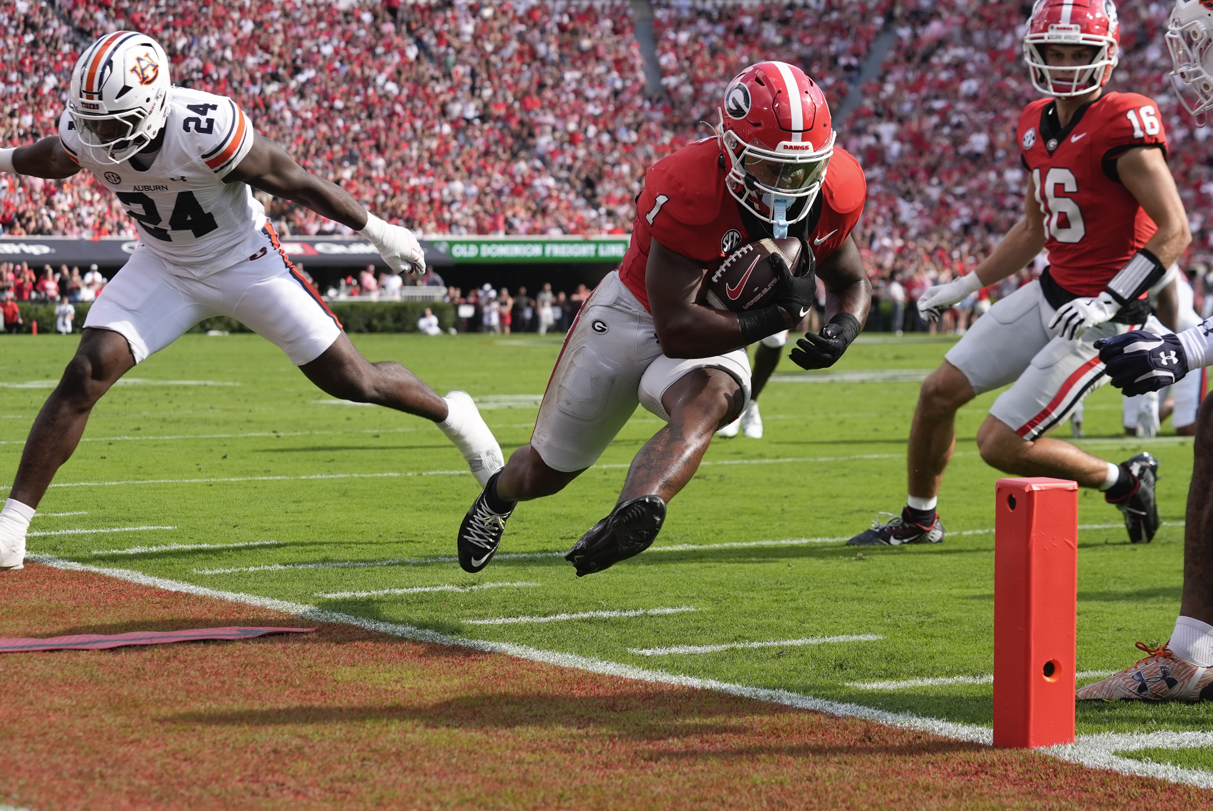 Georgia running back Trevor Etienne (1) is forced out of bounds by Auburn's Keyron Crawford (24) short of the end zone after making a catch in the first half of an NCAA college football game Saturday, Oct. 5, 2024, in Athens, Ga.