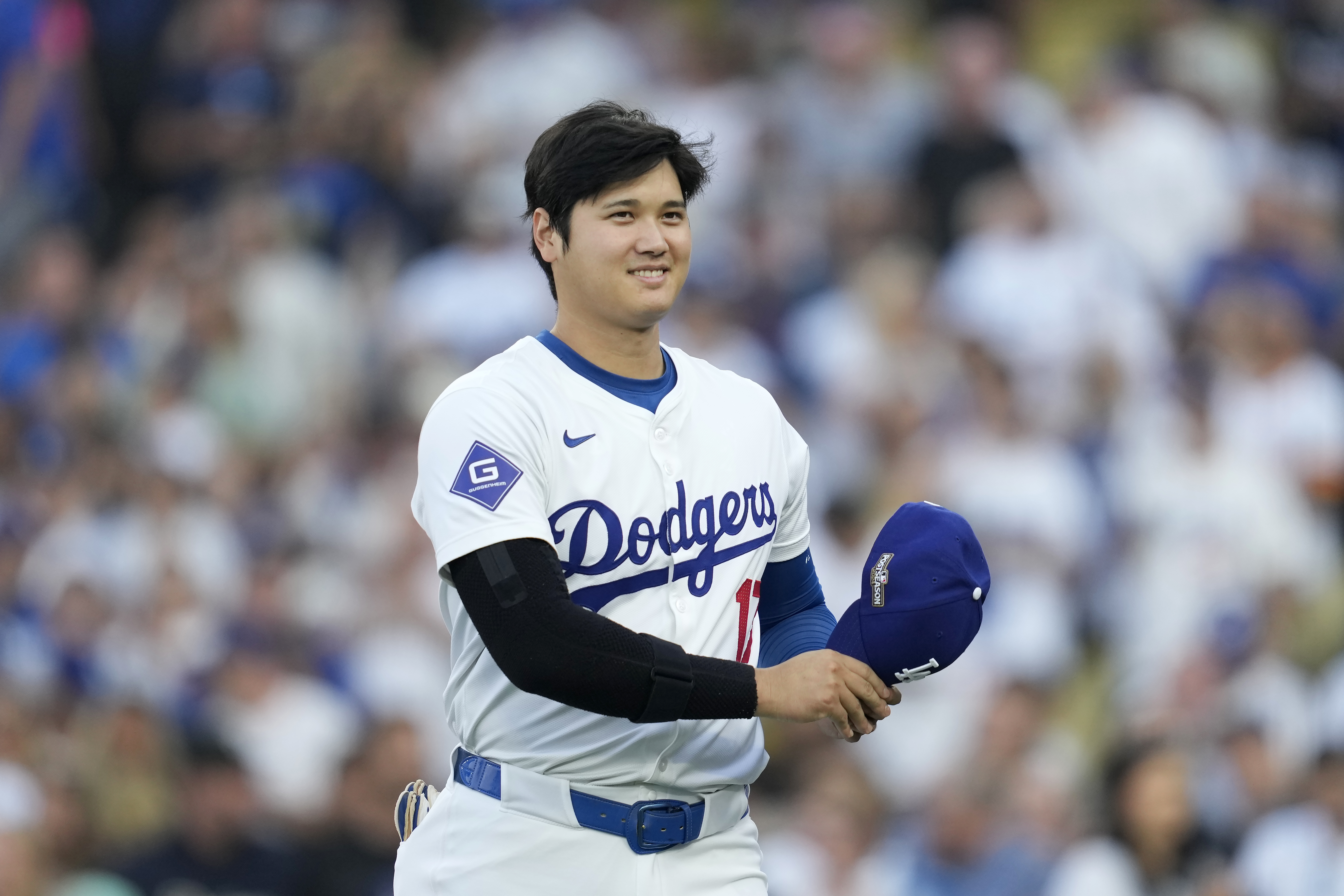Los Angeles Dodgers' Shohei Ohtani walks back to the dugout before Game 1 of baseball's NL Division Series against the San Diego Padres, Saturday, Oct. 5, 2024, in Los Angeles.