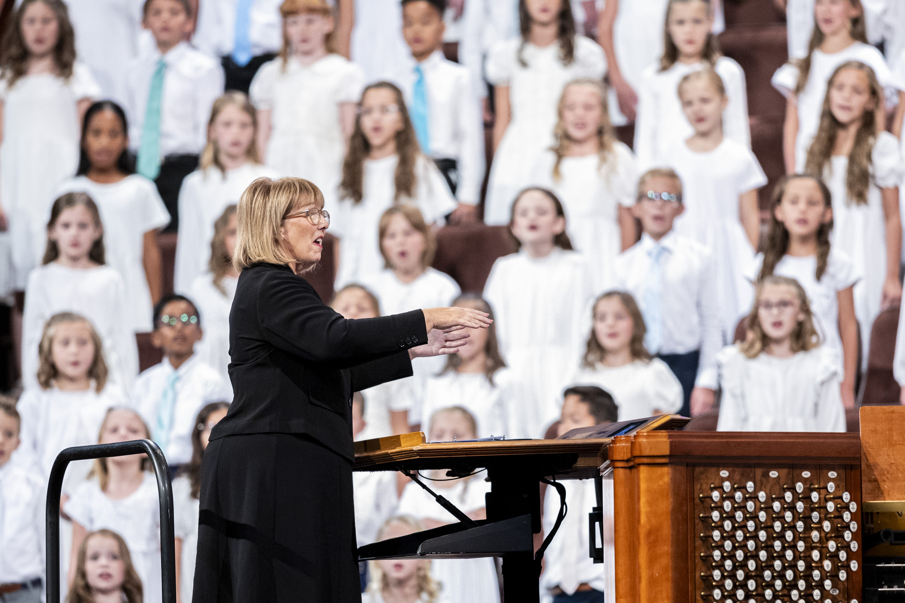 Leslie Walker directs a children’s choir from northern Utah during the afternoon session of the 194th Semiannual General Conference of The Church of Jesus Christ of Latter-day Saints held at the Conference Center in Salt Lake City on Saturday.