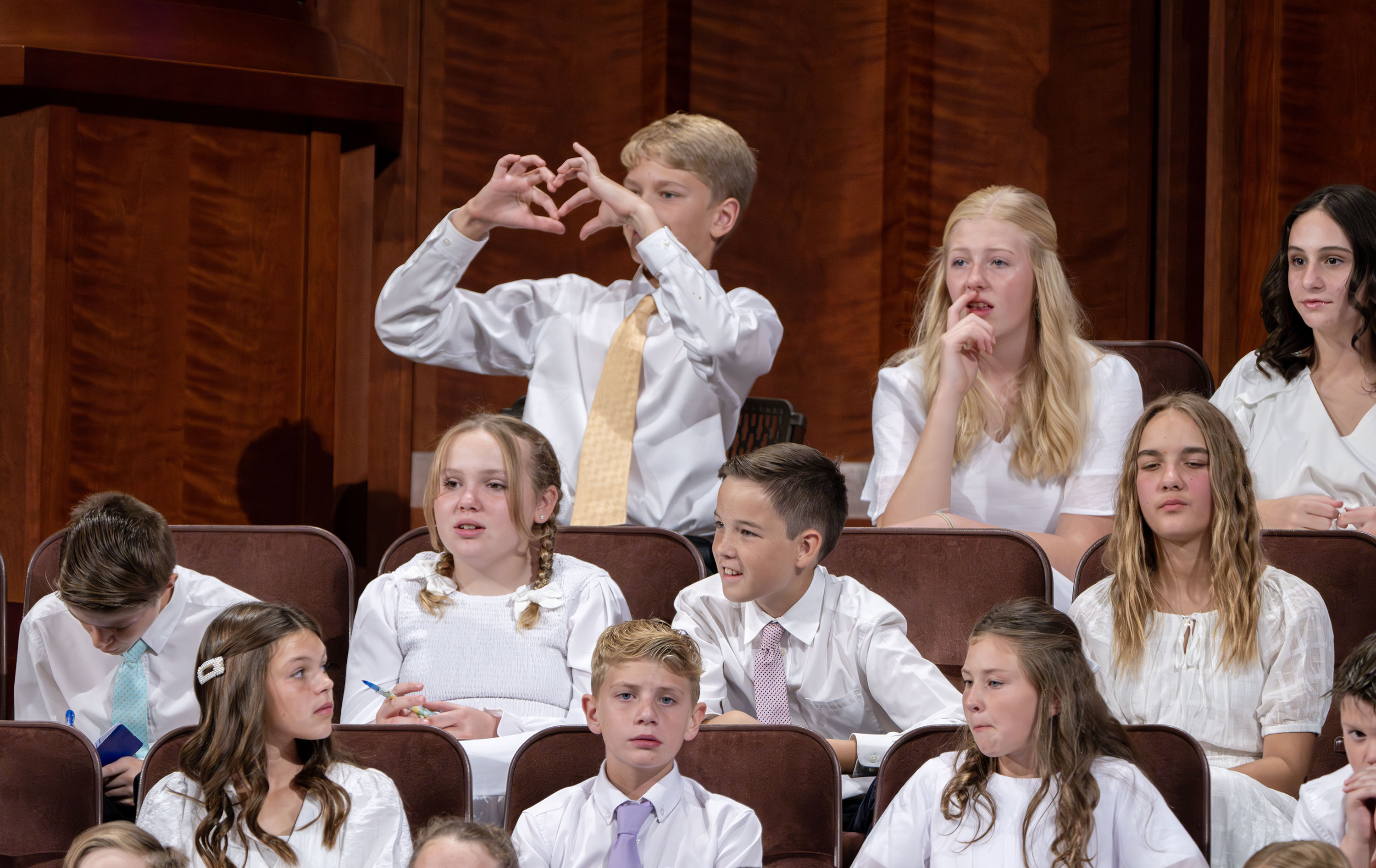 Youth in the choir prepare for the afternoon session of the 194th Semiannual General Conference of The Church of Jesus Christ of Latter-day Saints in the Conference Center in Salt Lake City on Saturday.