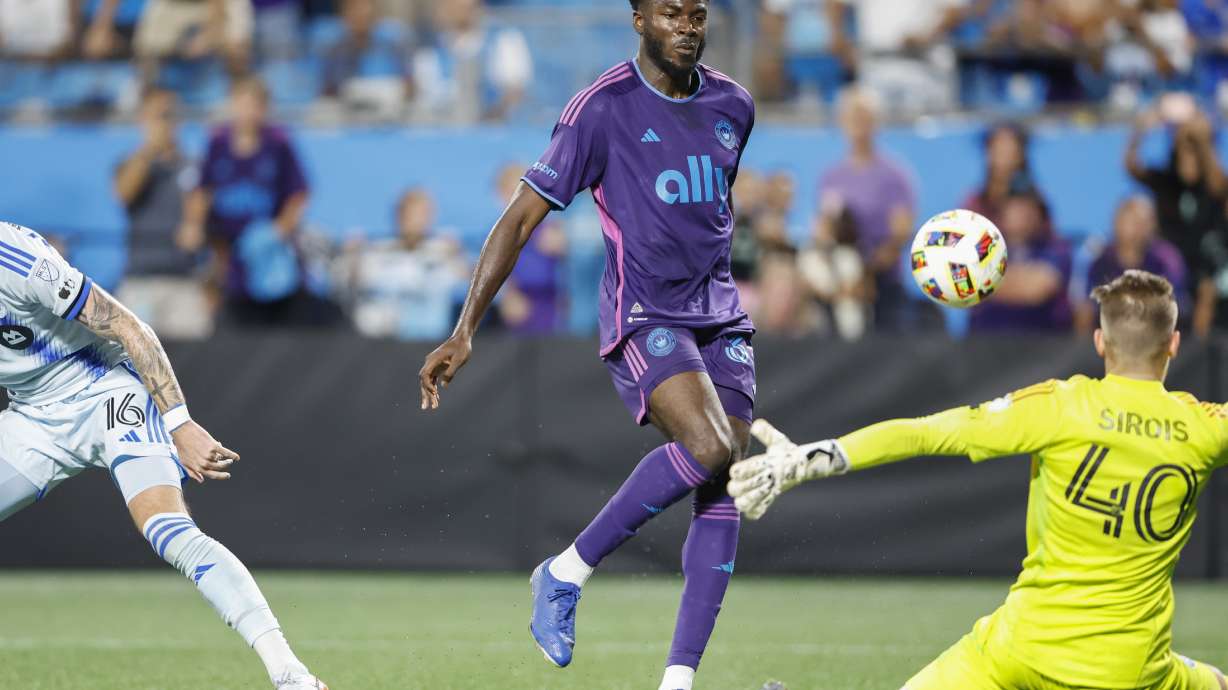 Charlotte FC forward Patrick Agyemang, center, scores a goal past CF Montréal goalkeeper Jonathan Sirois (40) as defender Joel Waterman (16) looks on during the second half of an MLS soccer match in Charlotte, N.C., Saturday, Oct. 5, 2024. Charlotte FC won 2-0.