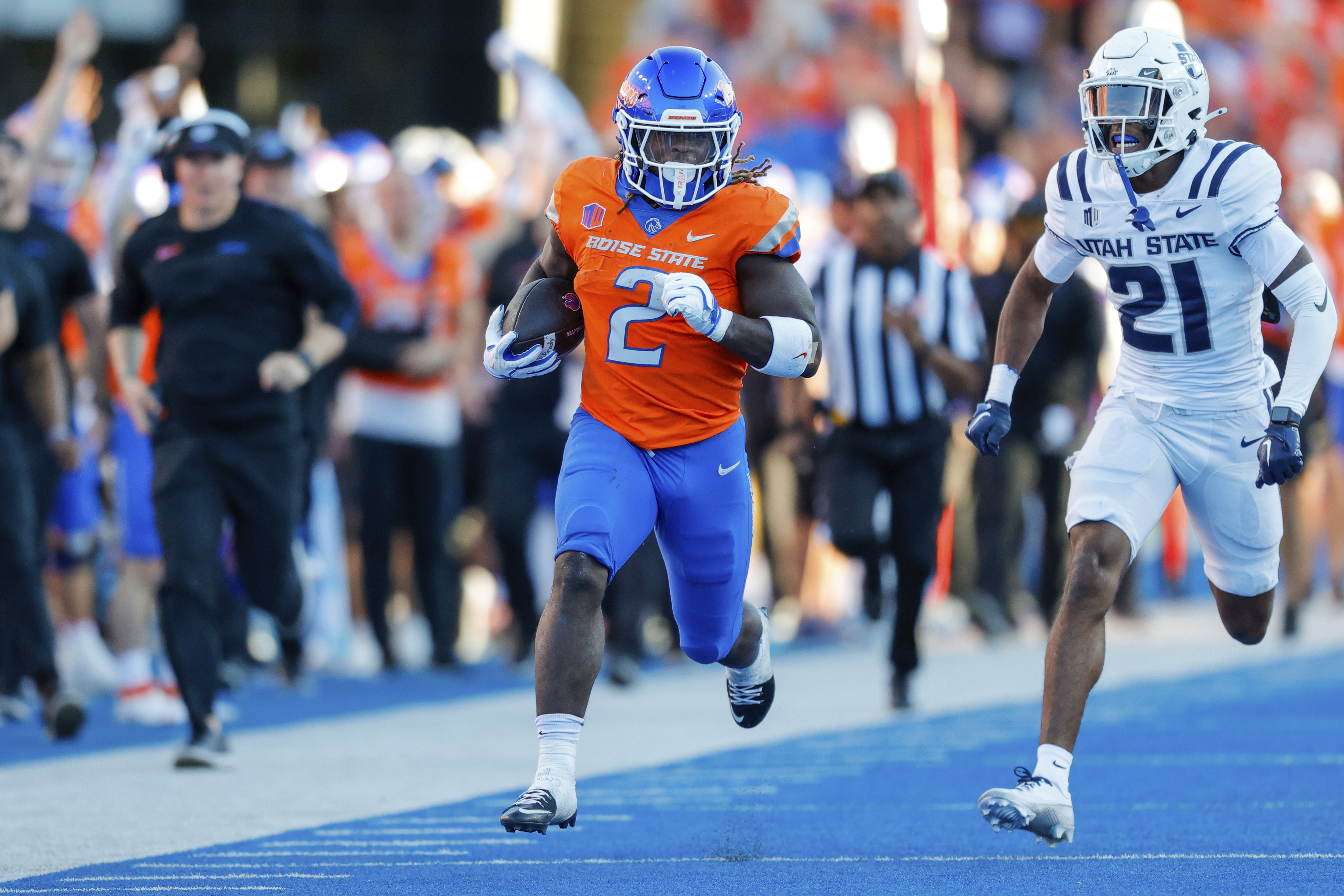Boise State running back Ashton Jeanty (2) runs away from Utah State safety Malik McConico (21) on a 75-yard touchdown run in the first half of an NCAA college football game, Saturday, Oct. 5, 2024, in Boise, Idaho. .