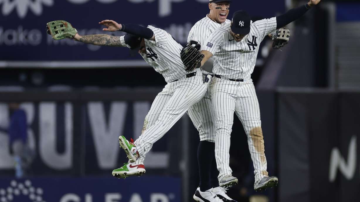 New York Yankees left fielder Alex Verdugo, left, center fielder Aaron Judge, center, and Juan Soto celebrate after beating the Kansas City Royals in Game 1 of the American League baseball division series, Saturday, Oct. 5, 2024, in New York.