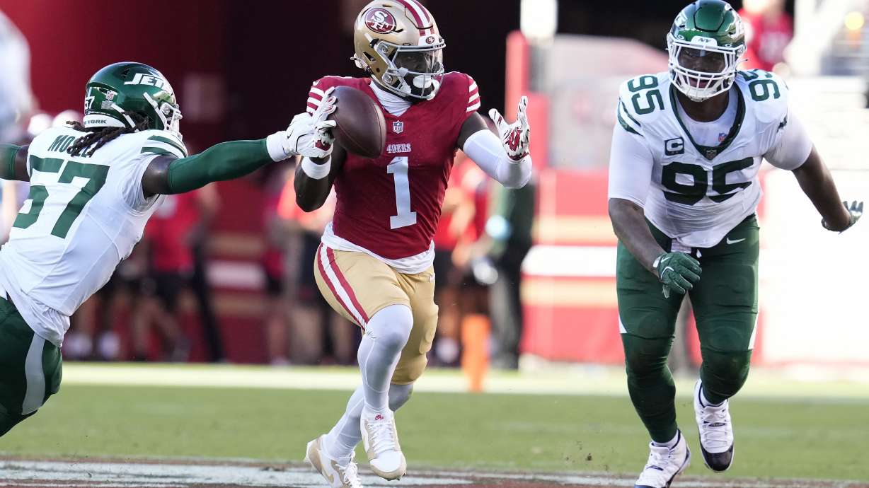 San Francisco 49ers wide receiver Deebo Samuel Sr. (1) runs between New York Jets linebacker C.J. Mosley and defensive tackle Quinnen Williams (95) during the first half of an NFL football game in Santa Clara, Calif., Monday, Sept. 9, 2024.