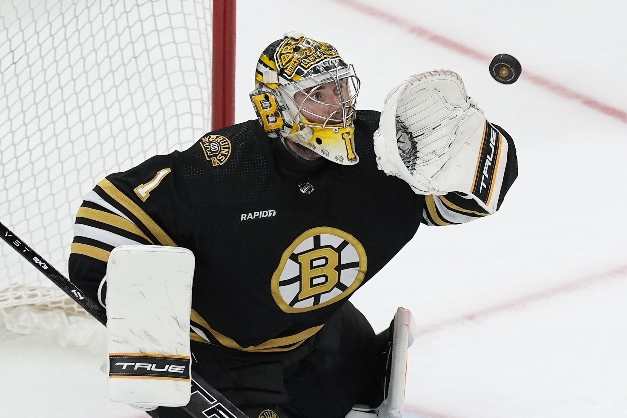 FILE - Boston Bruins' Jeremy Swayman makes a glove save during the third period in Game 6 of an NHL hockey Stanley Cup second-round playoff series against the Florida Panthers, May 17, 2024, in Boston.