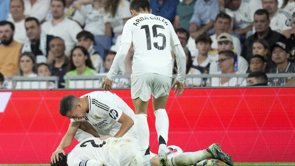 Real Madrid's Lucas Vazquez checks on his teammate Dani Carvajal during the La Liga soccer match between Real Madrid and Villareal in Madrid, Spain, on Saturday, Oct. 5, 2024.