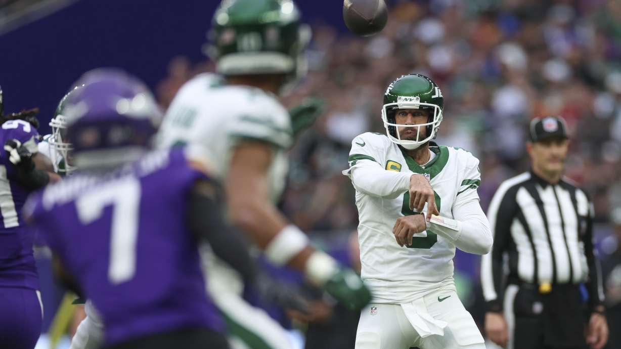 New York Jets quarterback Aaron Rodgers throws during the first half of an NFL football game against the Minnesota Vikings, Sunday, Oct. 6, 2024, at the Tottenham Hotspur stadium in London.