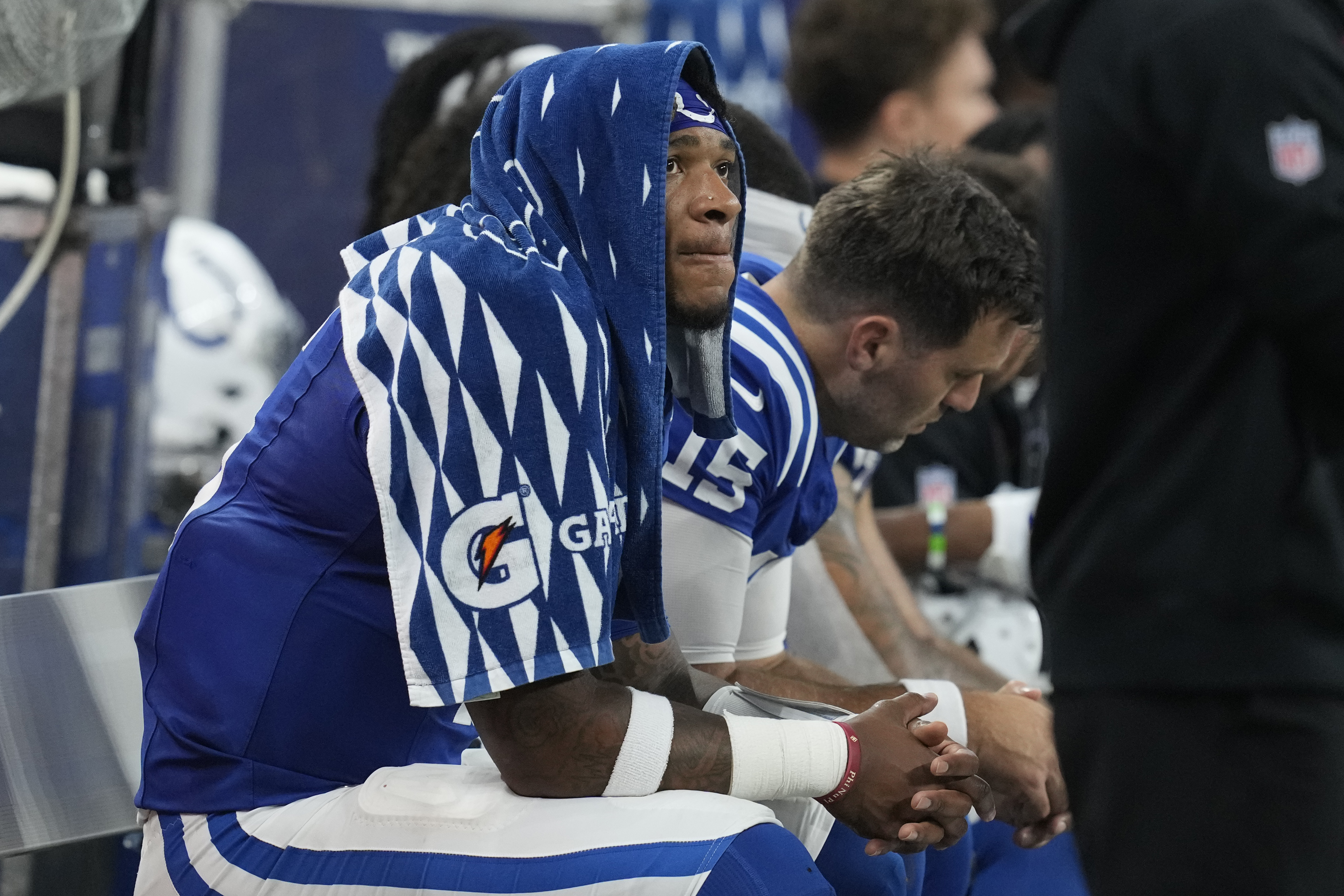 Indianapolis Colts quarterback Anthony Richardson, left, sits on the bench after being injured during the first half of an NFL football game against the Pittsburgh Steelers, Sunday, Sept. 29, 2024, in Indianapolis.