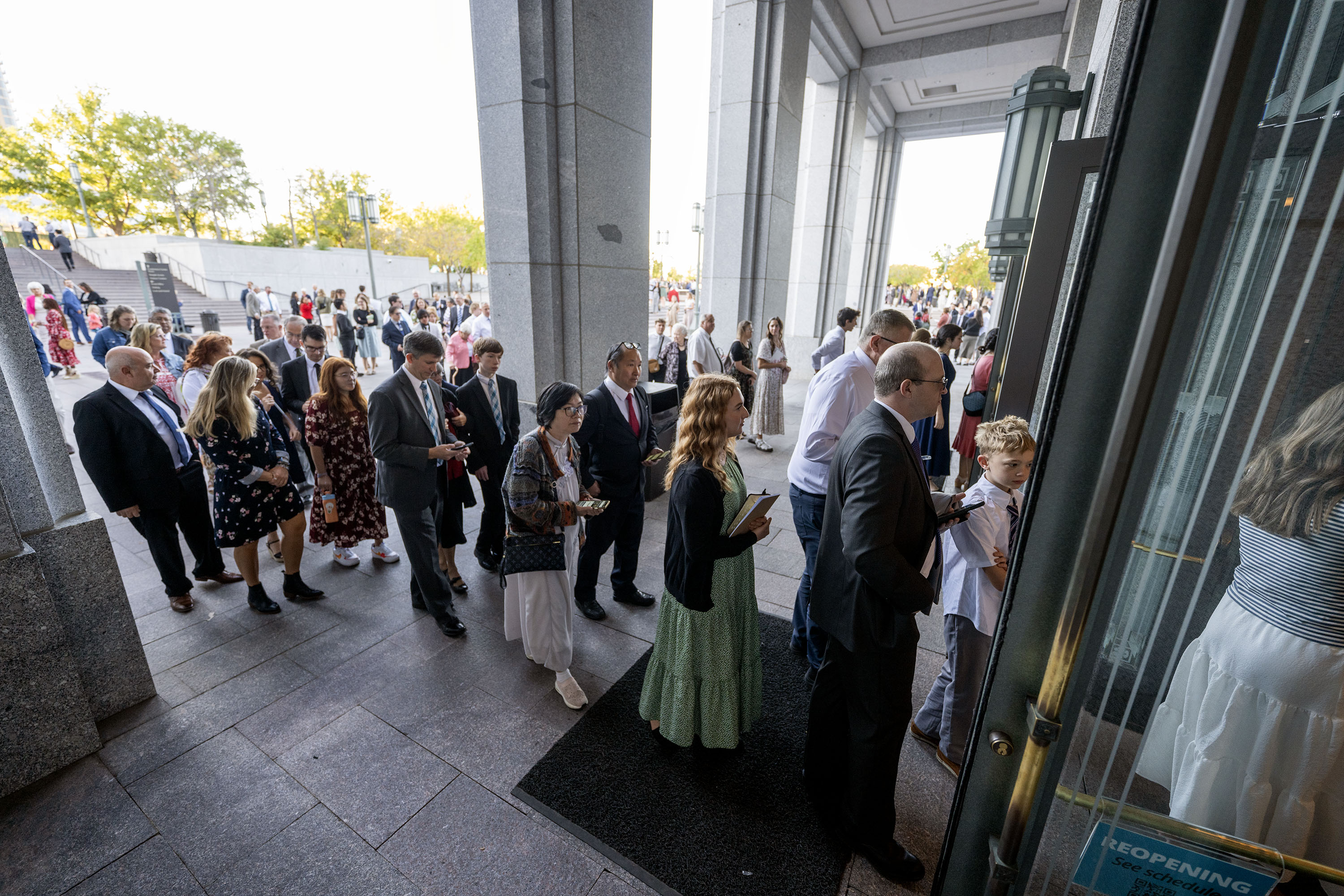 Audience members work their way inside prior to "Music & the Spoken Word" and the Sunday morning session of the 194th Semiannual General Conference of The Church of Jesus Christ of Latter-day Saints at the Conference Center in Salt Lake City on Sunday.