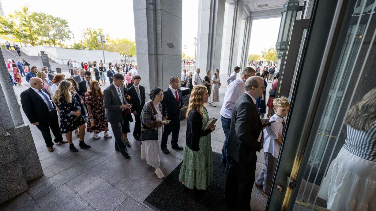 Audience members work their way inside prior to "Music & the Spoken Word" and the Sunday morning session of the 194th Semiannual General Conference of The Church of Jesus Christ of Latter-day Saints at the Conference Center in Salt Lake City on Sunday.