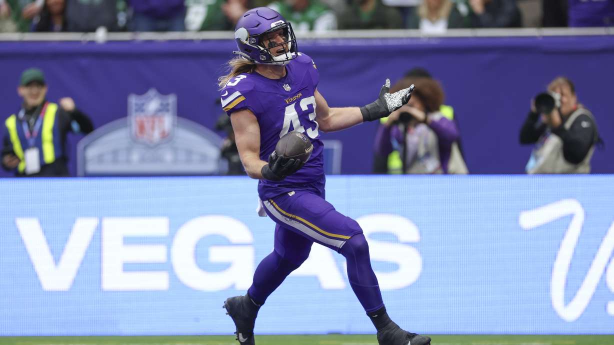 Minnesota Vikings' Andrew Van Ginkel celebrates as he scores after an interception during the first half of an NFL football game against the New York Jets, Sunday, Oct. 6, 2024, at the Tottenham Hotspur stadium in London.