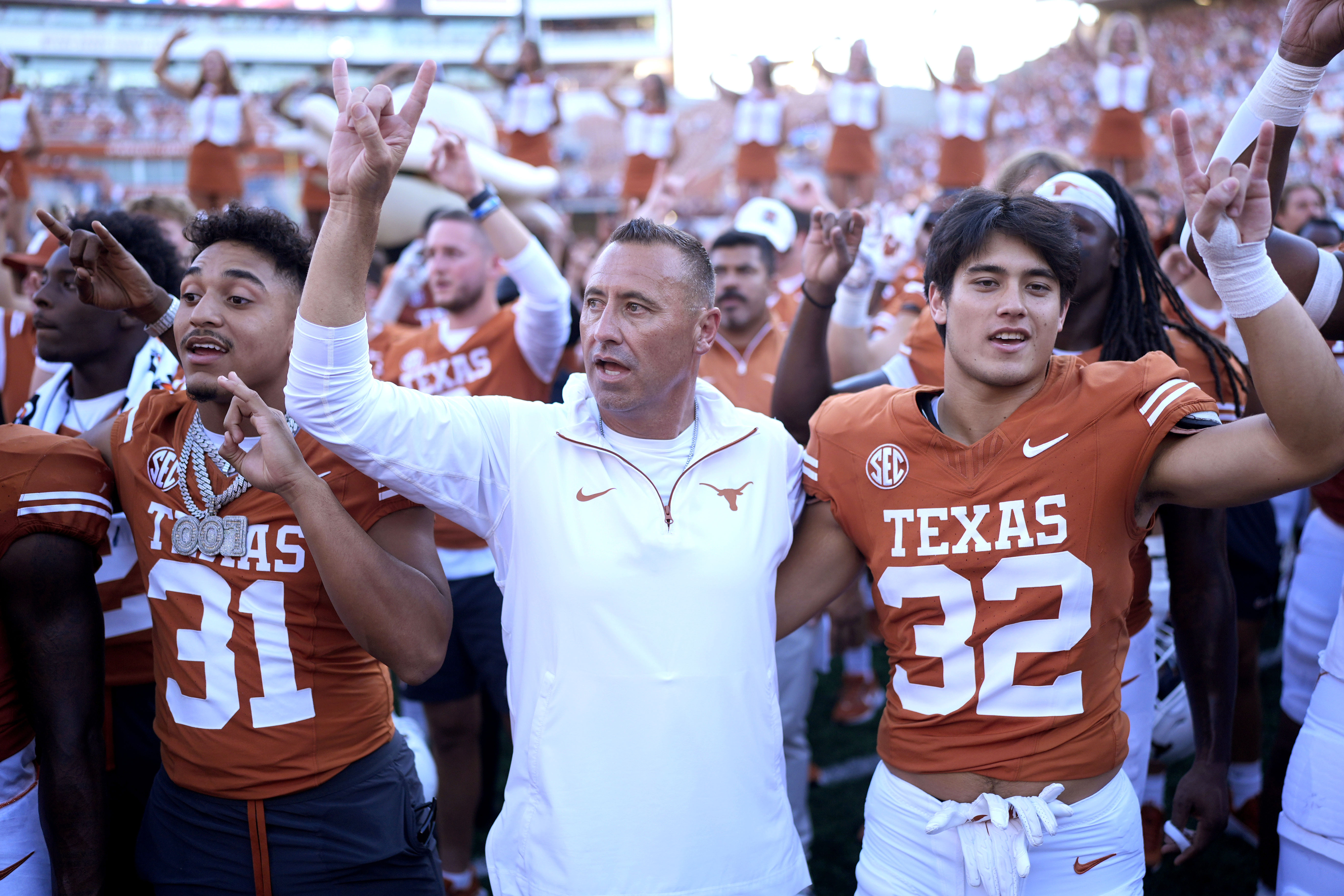 Texas head coach Steve Sarkisian, center, joins players for the school song following their win over Mississippi State in an NCAA college football game in Austin, Texas, Saturday, Sept. 28, 2024.