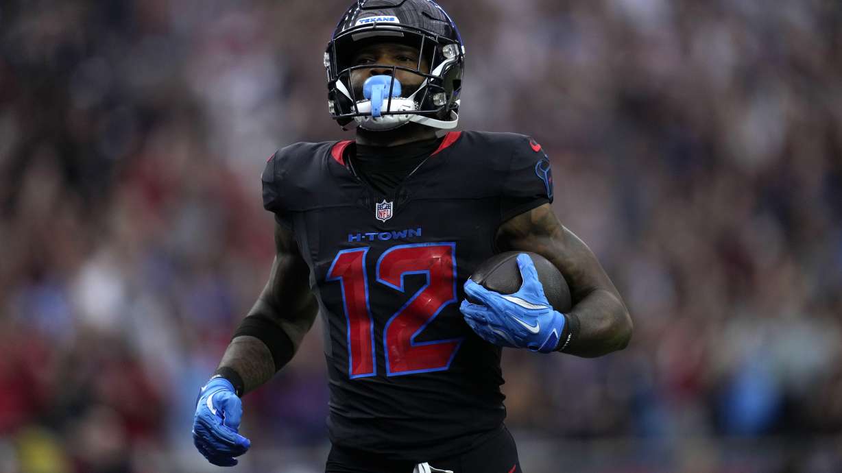 Houston Texans wide receiver Nico Collins scores on a 67-yard touchdown reception during the first half of an NFL football game Buffalo Bills, Sunday, Oct. 6, 2024, in Houston.