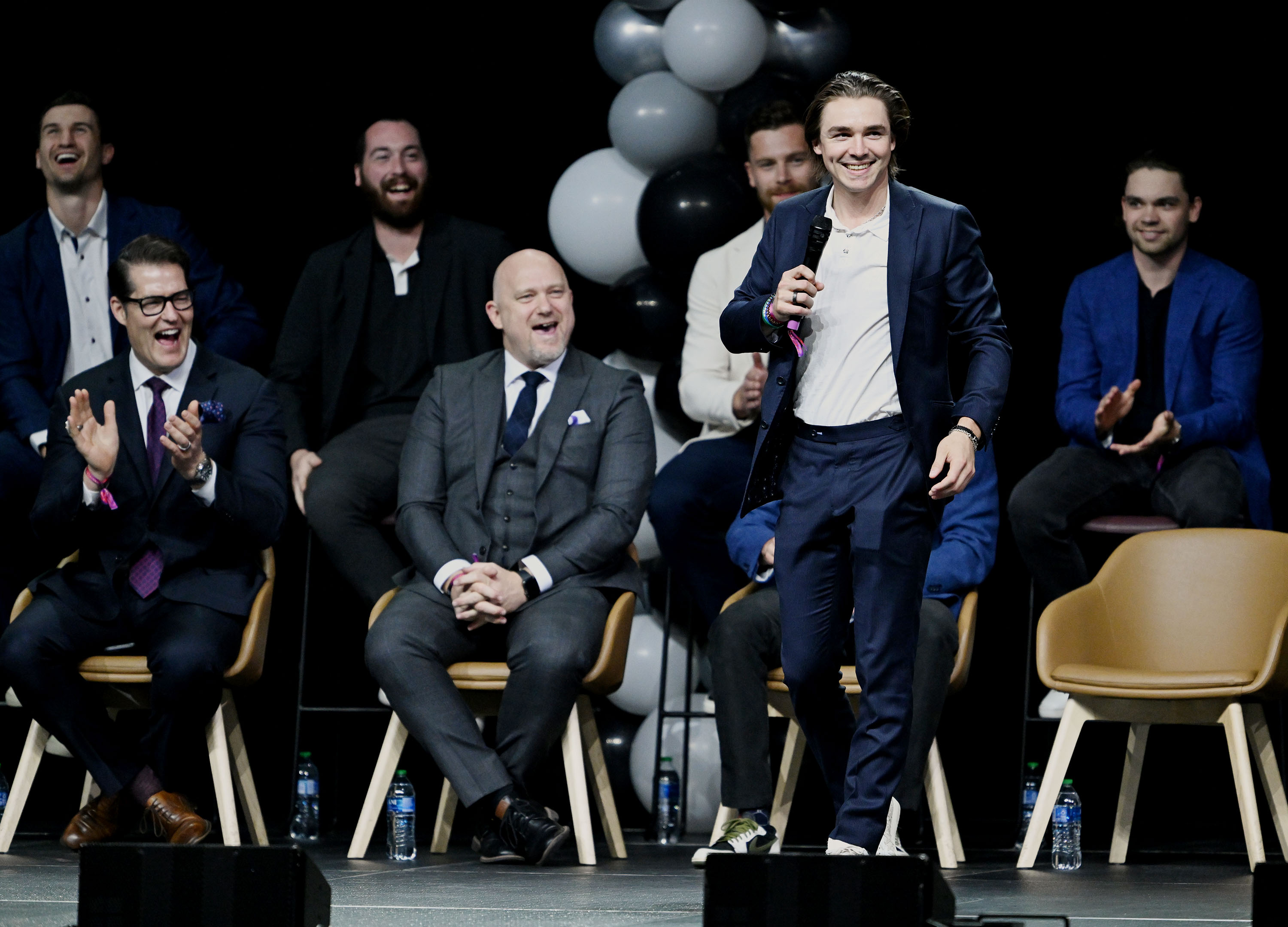 Members of the team react as Clayton Keller introduces himself to the fans during the NHL event at the Delta Center in Salt Lake City, as Utah’s NHL hockey team is introduced to fans on Wednesday, April 24, 2024.