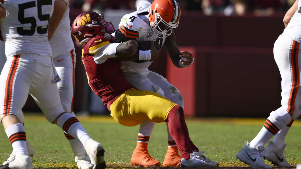 Cleveland Browns quarterback Deshaun Watson (4) is sacked by Washington Commanders linebacker Dante Fowler Jr. (6) during the second half of an NFL football game in Landover, Md., Sunday, Oct. 6, 2024.