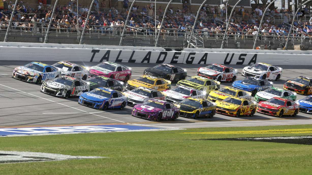 Drivers race down the front stretch four wide during a NASCAR Cup Series auto race at Talladega Superspeedway, Sunday, Oct. 6, 2024, in Talladega, Ala.