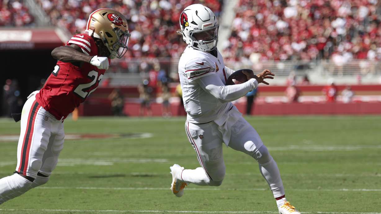 Arizona Cardinals quarterback Kyler Murray, right, runs against San Francisco 49ers cornerback Isaac Yiadom during the first half of an NFL football game in Santa Clara, Calif., Sunday, Oct. 6, 2024.
