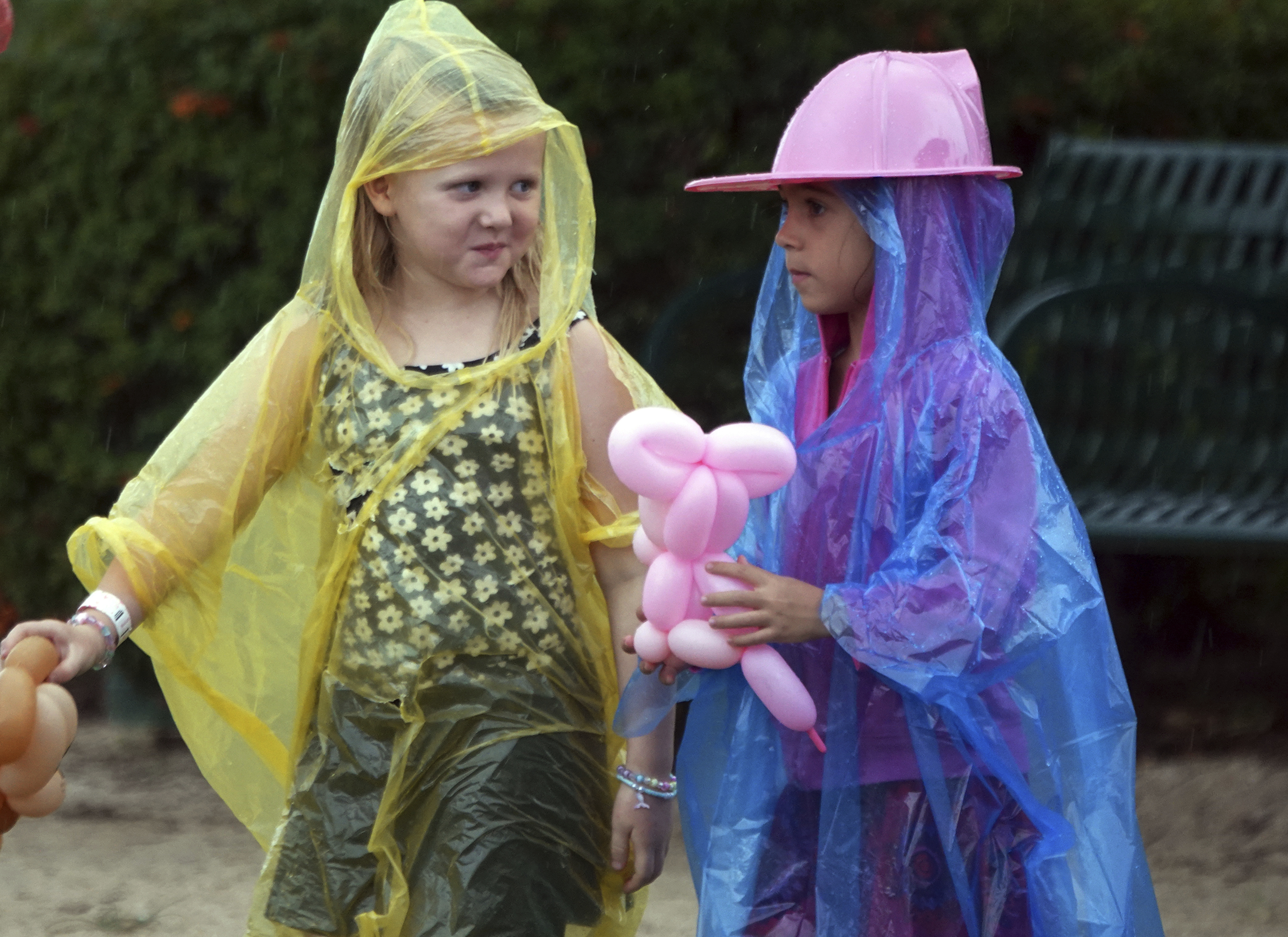 Chloe Fleming and Maya Teixiera don't let the rain from approaching Tropical Storm Milton dampen the day during Oktoberfest in Oakland Park, Fla., Sunday.