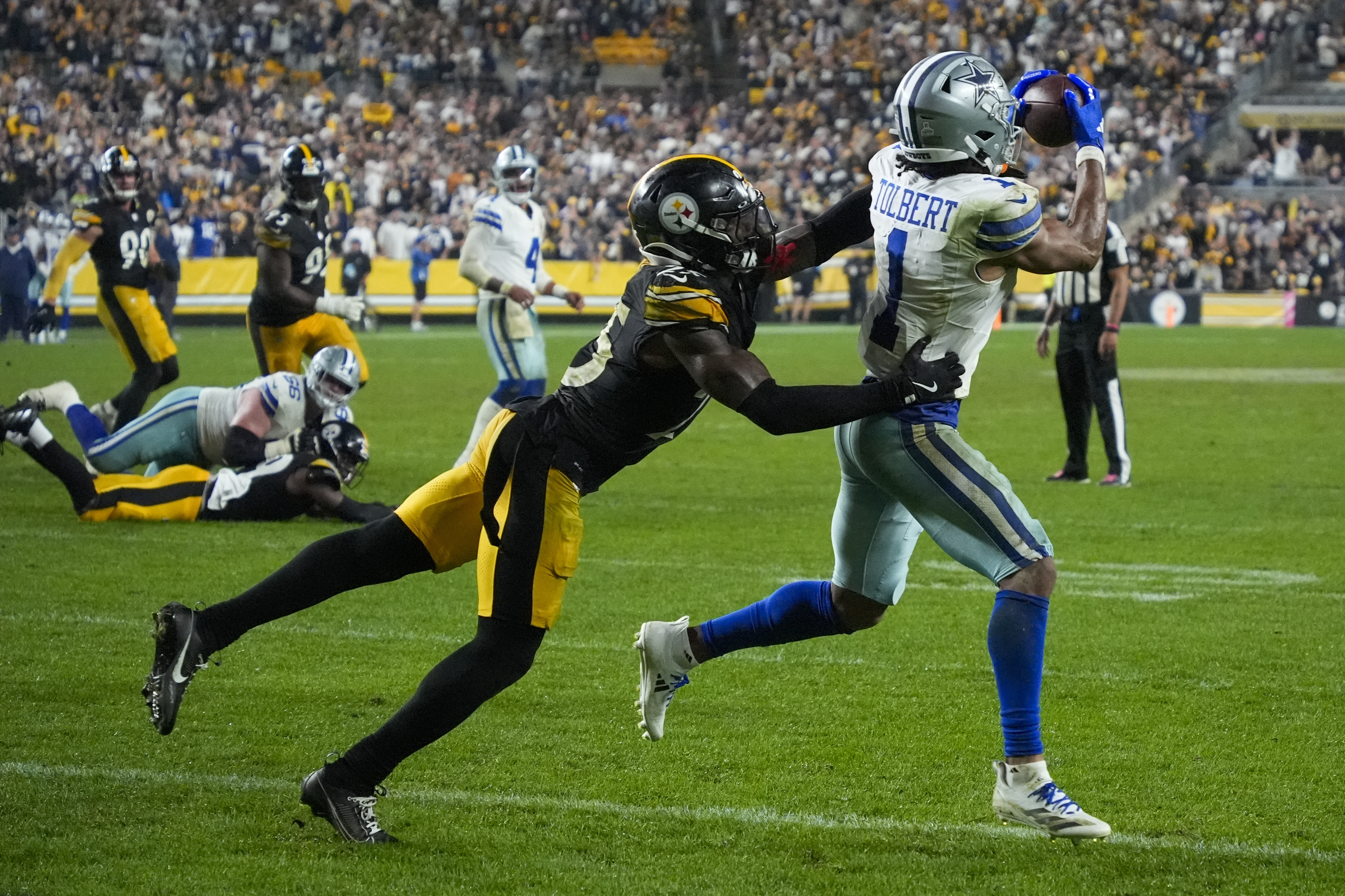 Dallas Cowboys wide receiver Jalen Tolbert (1) makes a touchdown catch as Pittsburgh Steelers safety DeShon Elliott tries to stop him during the second half of an NFL football game, early Monday, Oct. 7, 2024, in Pittsburgh. The Cowboys won 20-17.